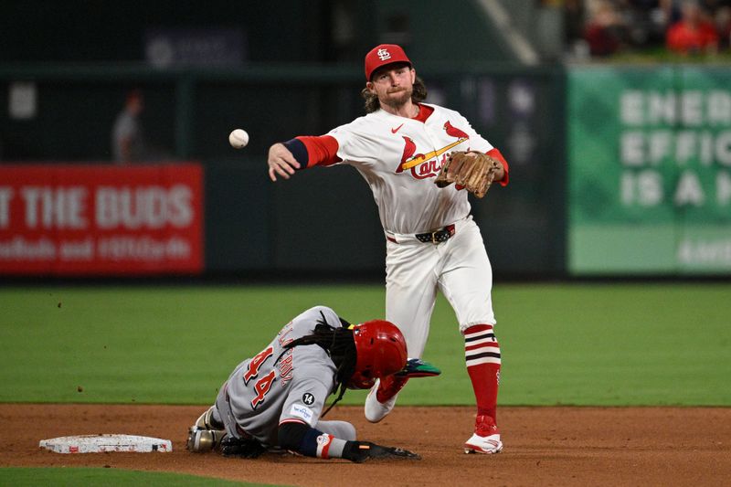 Sep 16, 2025; St. Louis, Missouri, USA; Cincinnati Reds shortstop Elly De La Cruz (44) is out at second base as St. Louis Cardinals second baseman Brendan Donovan (33) turns a double play in the fifth inning at Busch Stadium. Mandatory Credit: Joe Puetz-Imagn Images