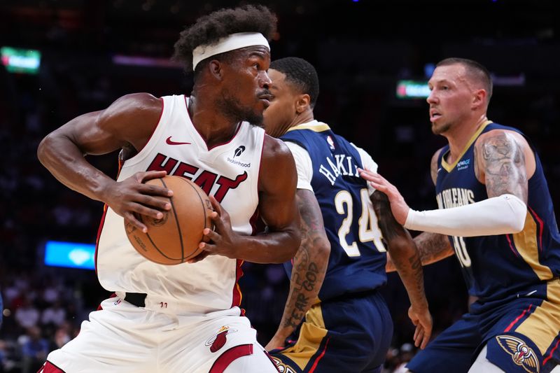 MIAMI, FLORIDA - OCTOBER 13: Jimmy Butler #22 of the Miami Heat dribbles the ball against the New Orleans Pelicans during the second quarter of a preseason game at Kaseya Center on October 13, 2024 in Miami, Florida. NOTE TO USER: User expressly acknowledges and agrees that, by downloading and or using this photograph, User is consenting to the terms and conditions of the Getty Images License Agreement. (Photo by Rich Storry/Getty Images)