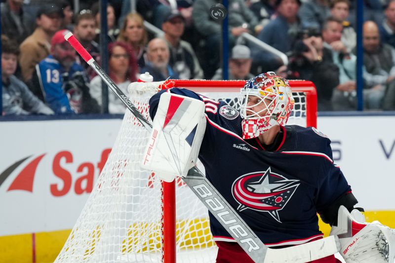 Oct 12, 2023; Columbus, Ohio, USA;  Columbus Blue Jackets goaltender Elvis Merzlikins (90) deflects the puck over the net in the game against the Philadelphia Flyers in the second period at Nationwide Arena. Mandatory Credit: Aaron Doster-USA TODAY Sports