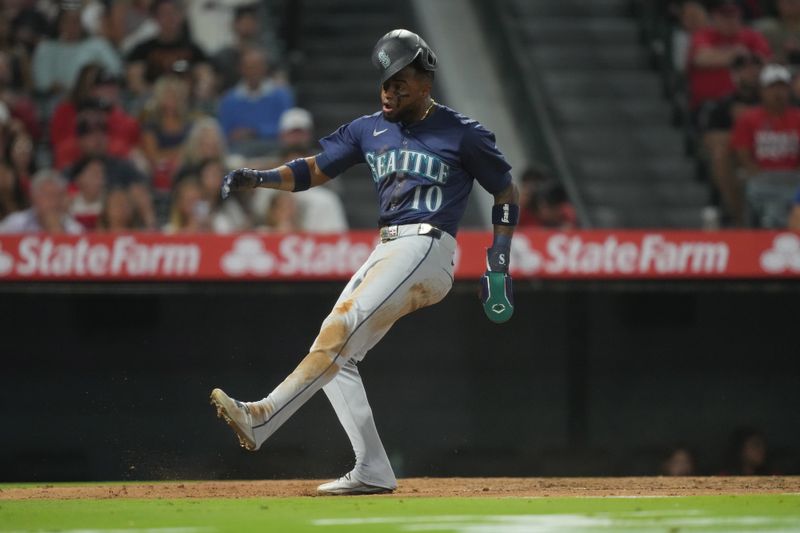 Aug 31, 2024; Anaheim, California, USA; Seattle Mariners center fielder Victor Robles (10) reacts after scoring in the fourth inning against the Los Angeles Angels at Angel Stadium. Mandatory Credit: Kirby Lee-USA TODAY Sports