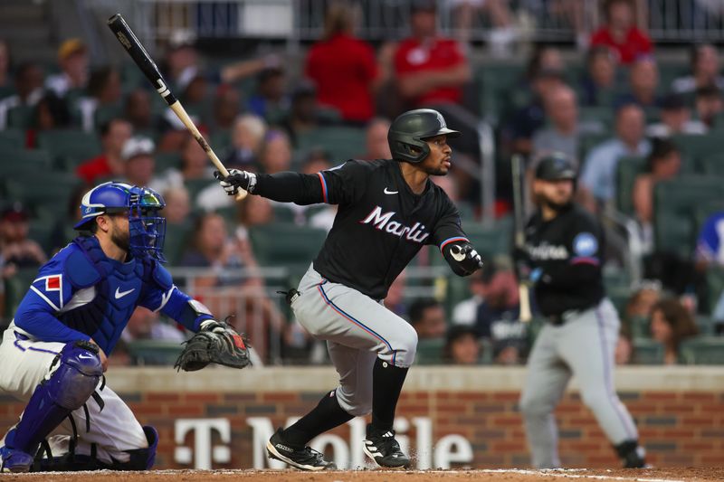 Aug 3, 2024; Atlanta, Georgia, USA; Miami Marlins shortstop Xavier Edwards (63) hits a single against the Atlanta Braves in the fifth inning at Truist Park. Mandatory Credit: Brett Davis-USA TODAY Sports