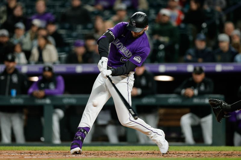 Apr 8, 2024; Denver, Colorado, USA; Colorado Rockies third base Ryan McMahon (24) hits a single in the fourth inning against the Arizona Diamondbacks at Coors Field. Mandatory Credit: Isaiah J. Downing-USA TODAY Sports