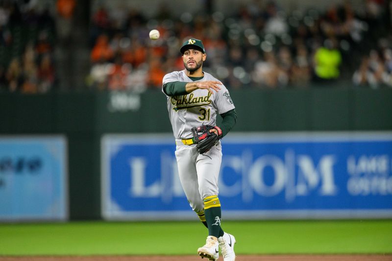 Apr 26, 2024; Baltimore, Maryland, USA; Oakland Athletics third base Abraham Toro (31) throws to first base during the seventh inning against the Baltimore Orioles at Oriole Park at Camden Yards. Mandatory Credit: Reggie Hildred-USA TODAY Sports