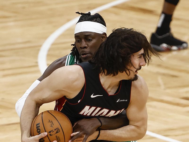 BOSTON, MA - APRIL 24: Jrue Holiday #4 of the Boston Celtics tries to tie up Jaime Jaquez Jr. #11 of the Miami Heat during the first quarter of game two of the Eastern Conference First Round Playoffs at TD Garden on April 24, 2024 in Boston, Massachusetts. NOTE TO USER: User expressly acknowledges and agrees that, by downloading and/or using this Photograph, user is consenting to the terms and conditions of the Getty Images License Agreement. (Photo By Winslow Townson/Getty Images)