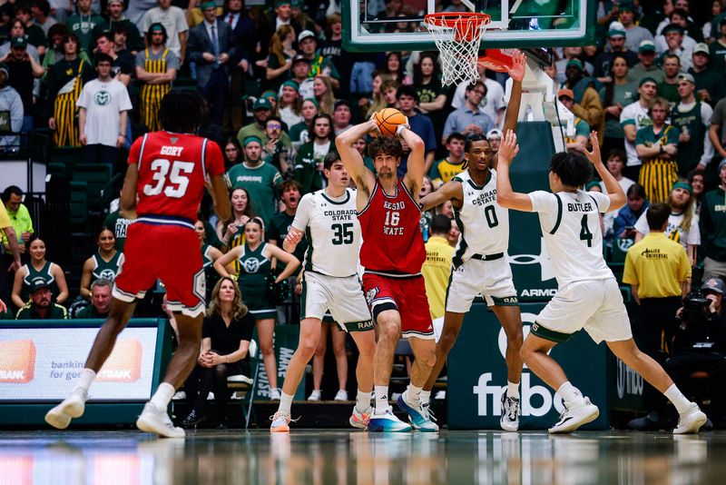 Feb 24, 2026; Fort Collins, Colorado, USA; Fresno State Bulldogs center Wilson Jacques (16) looks to pass the ball to forward Deshawn Gory (35) as Colorado State Rams forward Kyle Jorgensen (35) and forward Carey Booth (0) and guard Jase Butler (4) defend in the second half at Moby Arena. Mandatory Credit: Isaiah J. Downing-Imagn Images