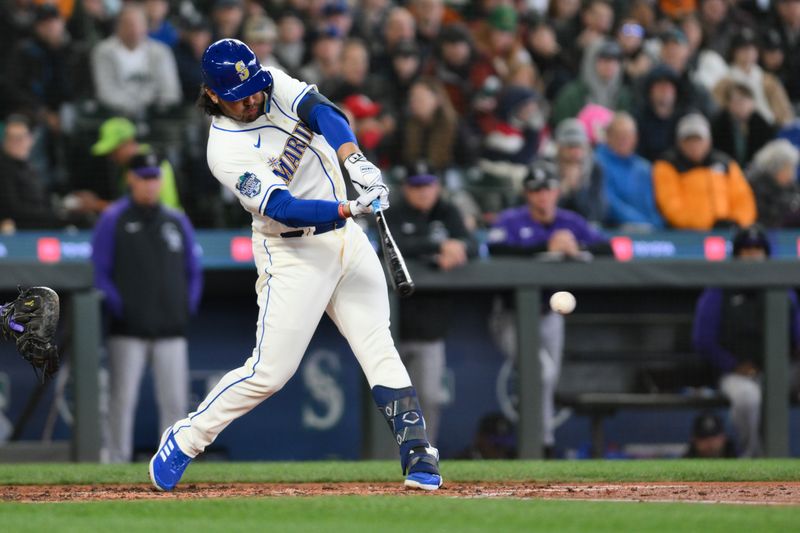 Apr 16, 2023; Seattle, Washington, USA; Seattle Mariners third baseman Eugenio Suarez (28) hits a single against the Colorado Rockies during the fourth inning at T-Mobile Park. Mandatory Credit: Steven Bisig-USA TODAY Sports