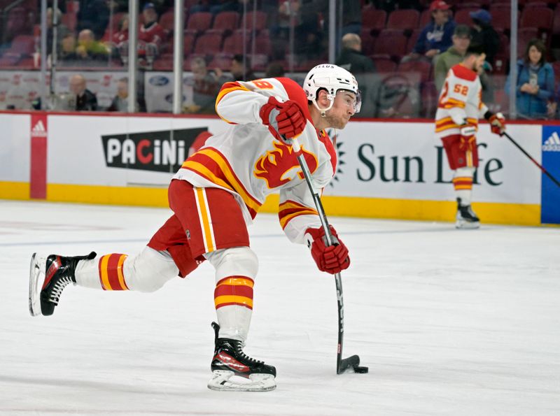 Nov 14, 2023; Montreal, Quebec, CAN; Calgary Flames forward Andrew Mangiapane (88) shoots the puck during the warm up period before the game against the Montreal Canadiens at the Bell Centre. Mandatory Credit: Eric Bolte-USA TODAY Sports