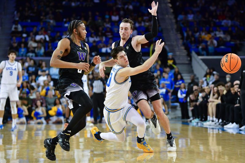 January 14, 2024; Los Angeles, California, USA; UCLA Bruins guard Lazar Stefanovic (10) collides with Washington Huskies forward Moses Wood (13) while playing for the ball during the second half at Pauley Pavilion. Mandatory Credit: Gary A. Vasquez-USA TODAY Sports