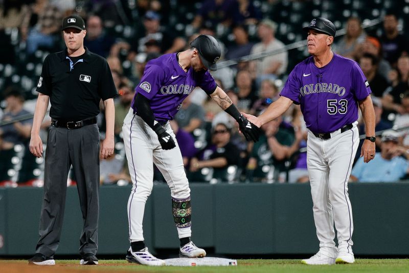 Sep 3, 2025; Denver, Colorado, USA; Colorado Rockies center fielder Brenton Doyle (9) reacts with first base coach Ronnie Gideon (53) after an RBI single in the fourth inning against the San Francisco Giants at Coors Field. Mandatory Credit: Isaiah J. Downing-Imagn Images
