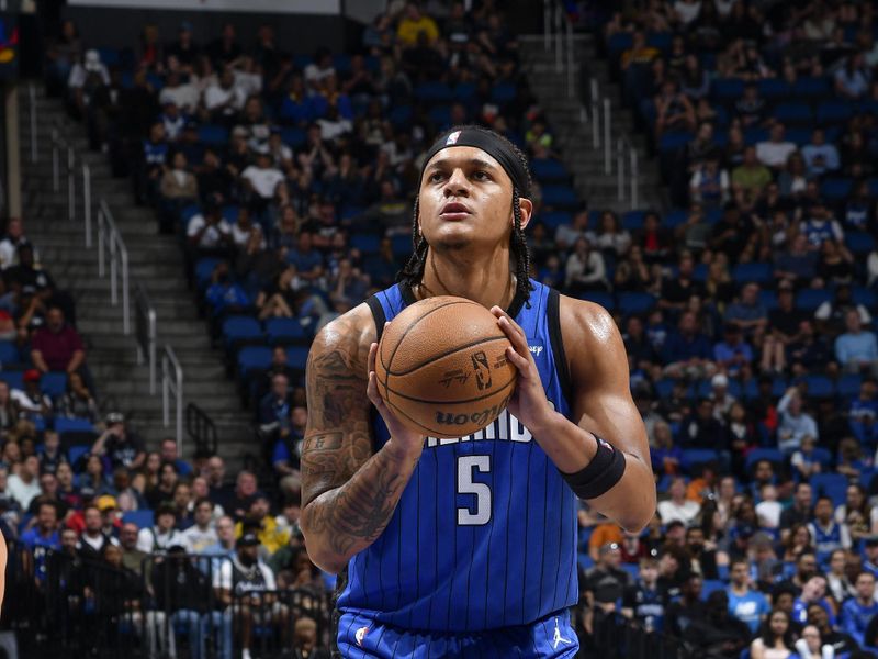 ORLANDO, FL - MARCH 10: Paolo Banchero #5 of the Orlando Magic shoots a free throw during the game on March 10, 2024 at Amway Center in Orlando, Florida. NOTE TO USER: User expressly acknowledges and agrees that, by downloading and or using this photograph, User is consenting to the terms and conditions of the Getty Images License Agreement. Mandatory Copyright Notice: Copyright 2024 NBAE (Photo by Fernando Medina/NBAE via Getty Images)