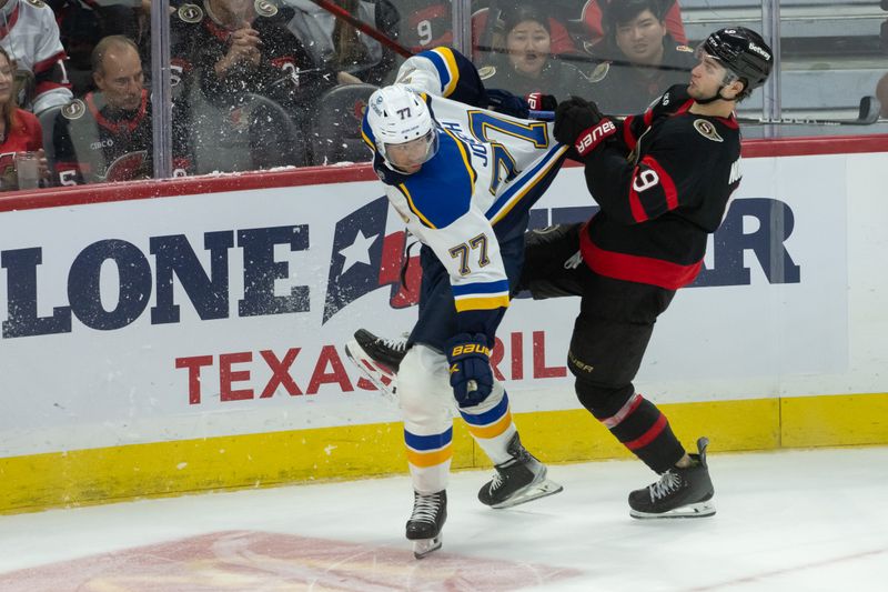 Oct 29, 2024; Ottawa, Ontario, CAN; St. Louis Blues defenseman Pierre-Olivier Joseph (77) is held up by  Ottawa Senators center Josh Norris (9) in the third period at the Canadian Tire Centre. Mandatory Credit: Marc DesRosiers-Imagn Images