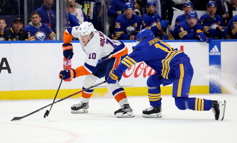 Mar 14, 2024; Buffalo, New York, USA;  Buffalo Sabres defenseman Henri Jokiharju (10) tries to block a pass by New York Islanders right wing Simon Holmstrom (10) during the first period at KeyBank Center. Mandatory Credit: Timothy T. Ludwig-USA TODAY Sports