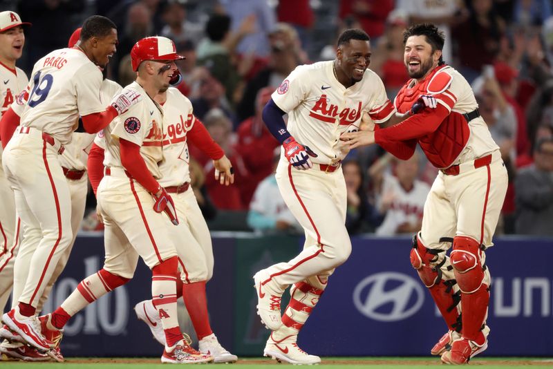 May 7, 2025; Anaheim, California, USA;  Los Angeles Angels right fielder Jorge Soler (12, second from right) celebrates with teammates after hitting a walk-off double during the ninth inning against the Toronto Blue Jays at Angel Stadium. Mandatory Credit: Kiyoshi Mio-Imagn Images