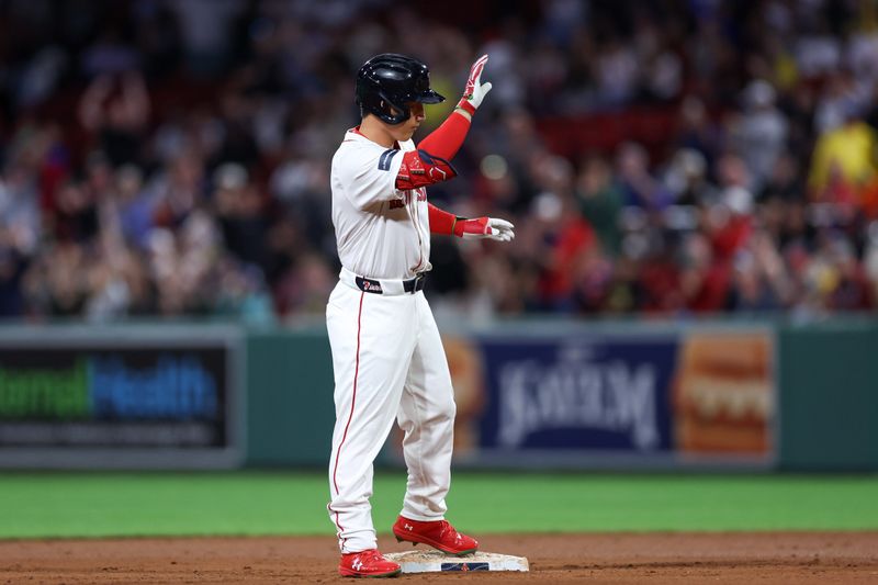 Sep 10, 2024; Boston, Massachusetts, USA; Boston Red Sox designated hitter Masataka Yoshida (7) reacts after hitting an RBI double during the eighth inning against the Baltimore Orioles at Fenway Park. Mandatory Credit: Paul Rutherford-Imagn Images