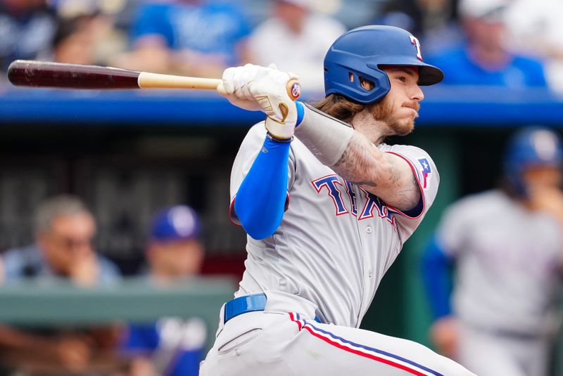 Apr 19, 2023; Kansas City, Missouri, USA; Texas Rangers catcher Jonah Heim (28) hits a single during the seventh inning against the Kansas City Royals at Kauffman Stadium. Mandatory Credit: Jay Biggerstaff-USA TODAY Sports