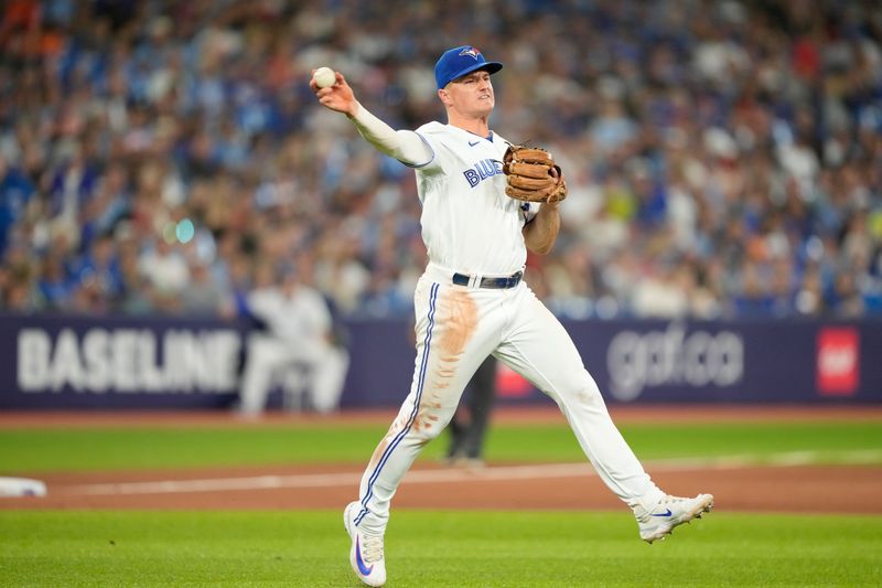 Jul 19, 2023; Toronto, Ontario, CAN; Toronto Blue Jays third baseman Matt Chapman (26) throwa to first but can't get San Diego Padres second baseman Ha-Seong Kim (not pictured) out during the ninth inning at Rogers Centre. Mandatory Credit: John E. Sokolowski-USA TODAY Sports