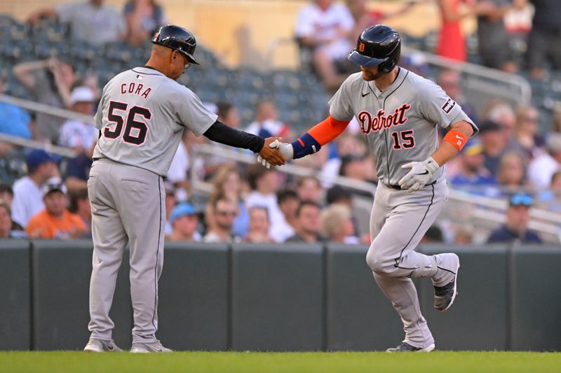 Jul 3, 2024; Minneapolis, Minnesota, USA; Detroit Tigers catcher Carson Kelly (15) celebrates his grand slam against the Minnesota Twins with third base coach Joey Cora (56) during the third inning at Target Field. Mandatory Credit: Nick Wosika-USA TODAY Sports