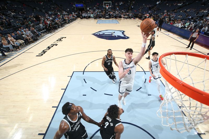 MEMPHIS, TN - February 26:  Jake LaRavia #3 of the Memphis Grizzlies drives to the basket during the game against the Brooklyn Nets on February 26, 2024 at FedExForum in Memphis, Tennessee. NOTE TO USER: User expressly acknowledges and agrees that, by downloading and or using this photograph, User is consenting to the terms and conditions of the Getty Images License Agreement. Mandatory Copyright Notice: Copyright 2024 NBAE (Photo by Joe Murphy/NBAE via Getty Images)