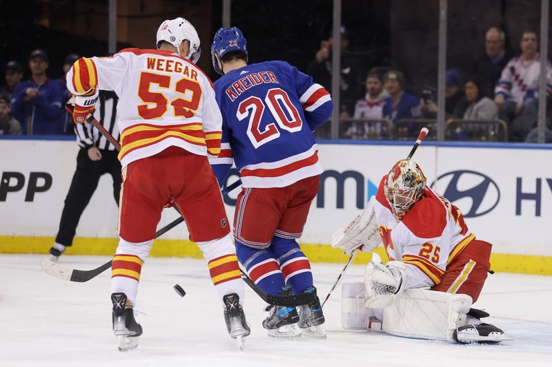 Feb 12, 2024; New York, New York, USA; New York Rangers left wing Chris Kreider (20) fights for the puck against Calgary Flames defenseman MacKenzie Weegar (52) and goaltender Jacob Markstrom (25) during the first period at Madison Square Garden. Mandatory Credit: Brad Penner-USA TODAY Sports