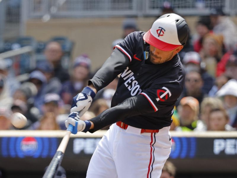 Apr 20, 2024; Minneapolis, Minnesota, USA; Minnesota Twins right fielder Trevor Larnach (9) hits a sacrifice fly against the Detroit Tigers in the fifth inning at Target Field. Mandatory Credit: Bruce Kluckhohn-USA TODAY Sports