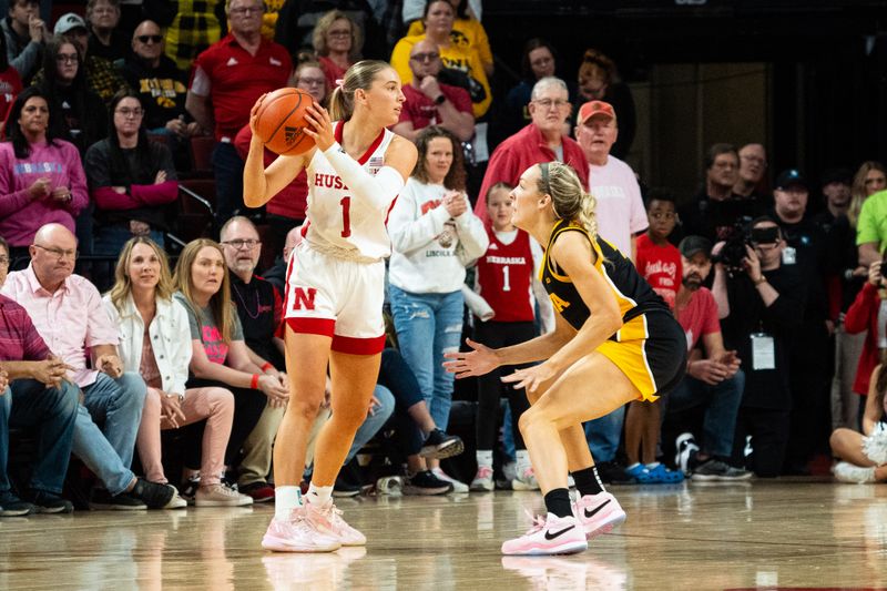 Feb 11, 2024; Lincoln, Nebraska, USA; Nebraska Cornhuskers guard Jaz Shelley (1) looks to pass against Iowa Hawkeyes guard Molly Davis (1) during the fourth quarter at Pinnacle Bank Arena. Mandatory Credit: Dylan Widger-USA TODAY Sports