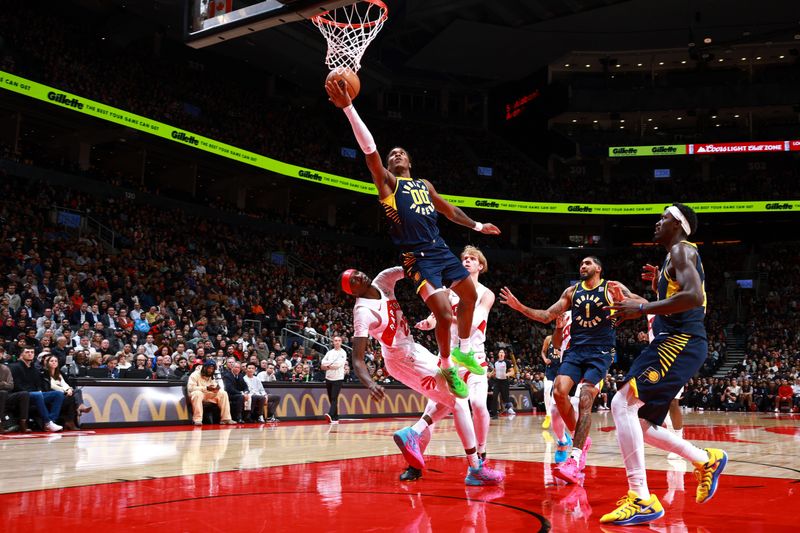 TORONTO, CANADA - NOVEMBER 18: Bennedict Mathurin #00 of the Indiana Pacers drives to the basket during the game against the Toronto Raptors on November 18, 2024 at the Scotiabank Arena in Toronto, Ontario, Canada.  NOTE TO USER: User expressly acknowledges and agrees that, by downloading and or using this Photograph, user is consenting to the terms and conditions of the Getty Images License Agreement.  Mandatory Copyright Notice: Copyright 2024 NBAE (Photo by Vaughn Ridley/NBAE via Getty Images)