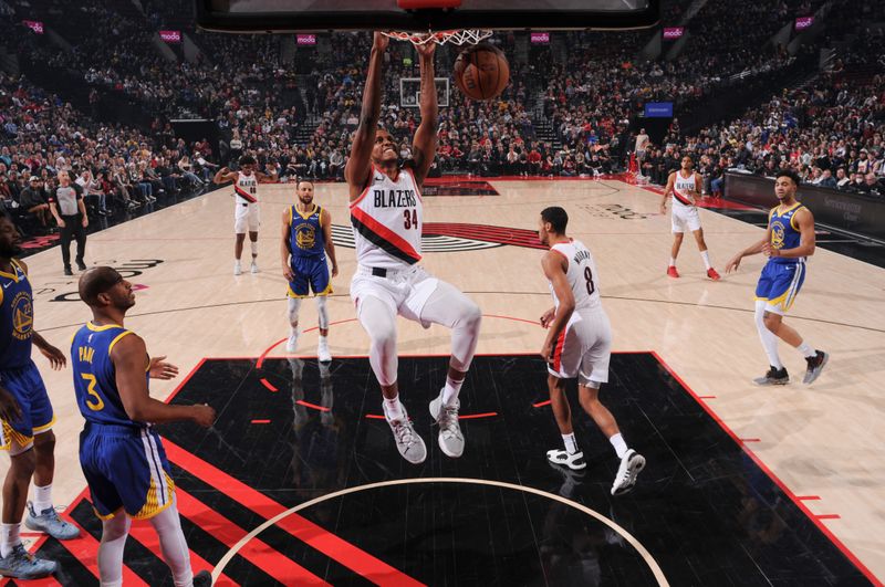 PORTLAND, OR - APRIL 11:  Jabari Walker #34 of the Portland Trail Blazers slam dunk the ball during the game  on April 11, 2024 at the Moda Center Arena in Portland, Oregon. NOTE TO USER: User expressly acknowledges and agrees that, by downloading and or using this photograph, user is consenting to the terms and conditions of the Getty Images License Agreement. Mandatory Copyright Notice: Copyright 2024 NBAE (Photo by Cameron Browne/NBAE via Getty Images)