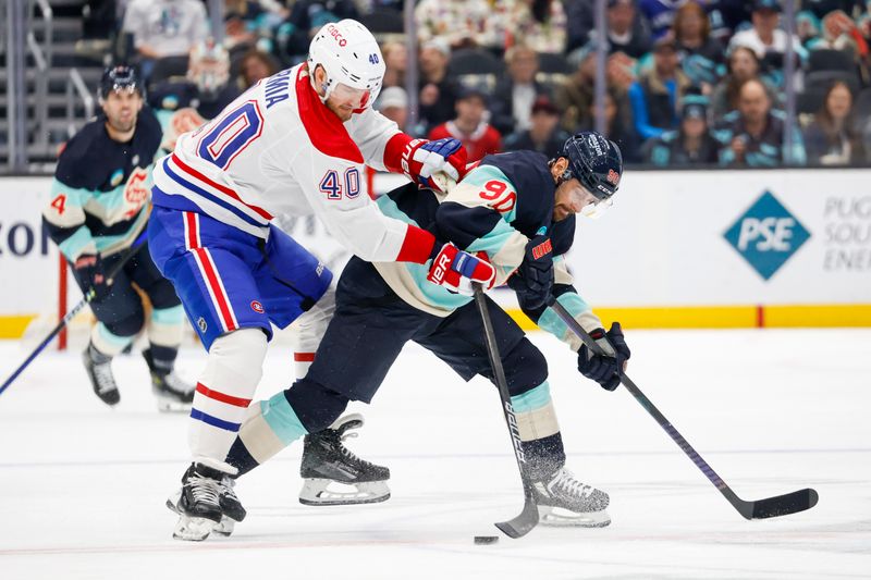 Mar 24, 2024; Seattle, Washington, USA; Montreal Canadiens right wing Joel Armia (40) and Seattle Kraken left wing Tomas Tatar (90) compete for a loose puck during the first period at Climate Pledge Arena. Mandatory Credit: Joe Nicholson-USA TODAY Sports