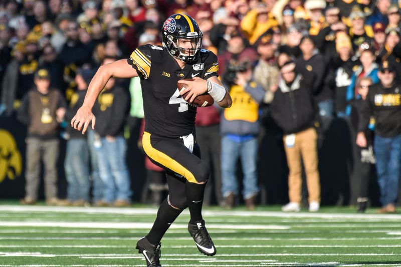 Nov 16, 2019; Iowa City, IA, USA; Iowa Hawkeyes quarterback Nate Stanley (4) runs with the ball during the first quarter against the Minnesota Golden Gophers at Kinnick Stadium. Mandatory Credit: Jeffrey Becker-USA TODAY Sports