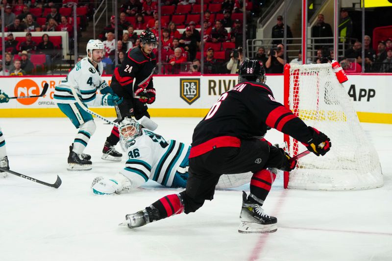 Oct 27, 2023; Raleigh, North Carolina, USA; Carolina Hurricanes left wing Teuvo Teravainen (86) scores a goal past San Jose Sharks goaltender Kaapo Kahkonen (36) during the first period at PNC Arena. Mandatory Credit: James Guillory-USA TODAY Sports