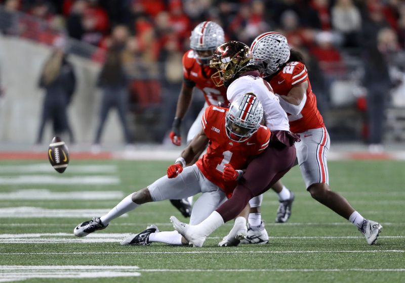 Nov 18, 2023; Columbus, Ohio, USA; Ohio State Buckeyes cornerback Davison Igbinosun (1) and linebacker Steele Chambers (22) break up the pass intended for Minnesota Golden Gophers wide receiver Daniel Jackson (9) during the second half at Ohio Stadium. Mandatory Credit: Joseph Maiorana-USA TODAY Sports