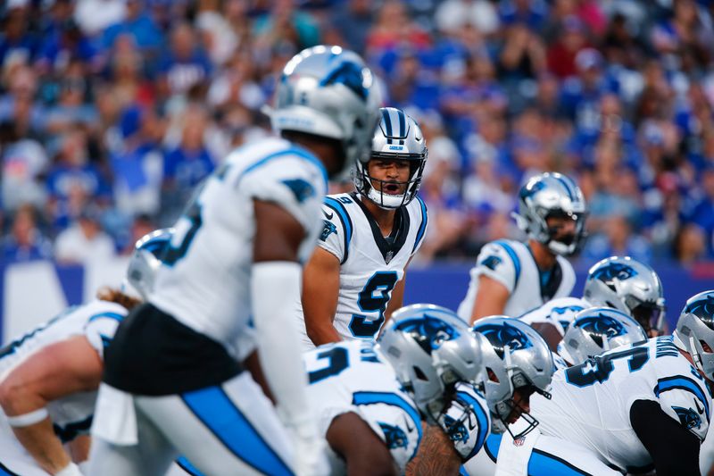 Carolina Panthers quarterback Bryce Young, center, looks over the line of scrimmage during the first half of an NFL preseason football game against the New York Giants, Friday, Aug. 18, 2023, in East Rutherford, N.J. (AP Photo/John Munson)