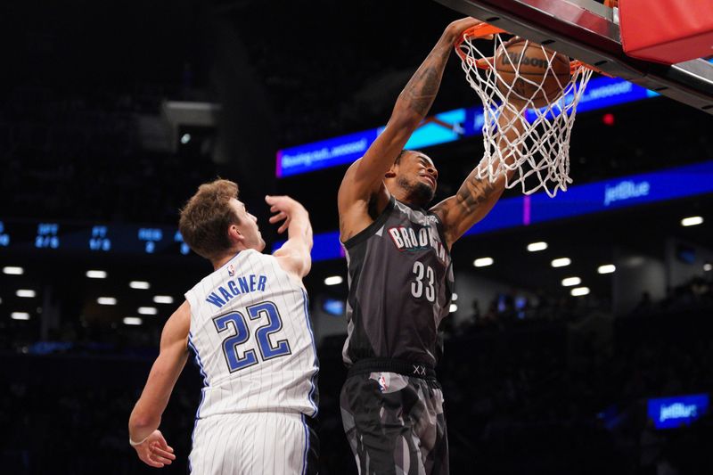 NEW YORK, NEW YORK - DECEMBER 01: Nic Claxton #33 of the Brooklyn Nets dunks the ball against the Orlando Magic during the first half at Barclays Center on December 01, 2024 in New York City. NOTE TO USER: User expressly acknowledges and agrees that, by downloading and or using this photograph, User is consenting to the terms and conditions of the Getty Images License Agreement. (Photo by Evan Bernstein/Getty Images)