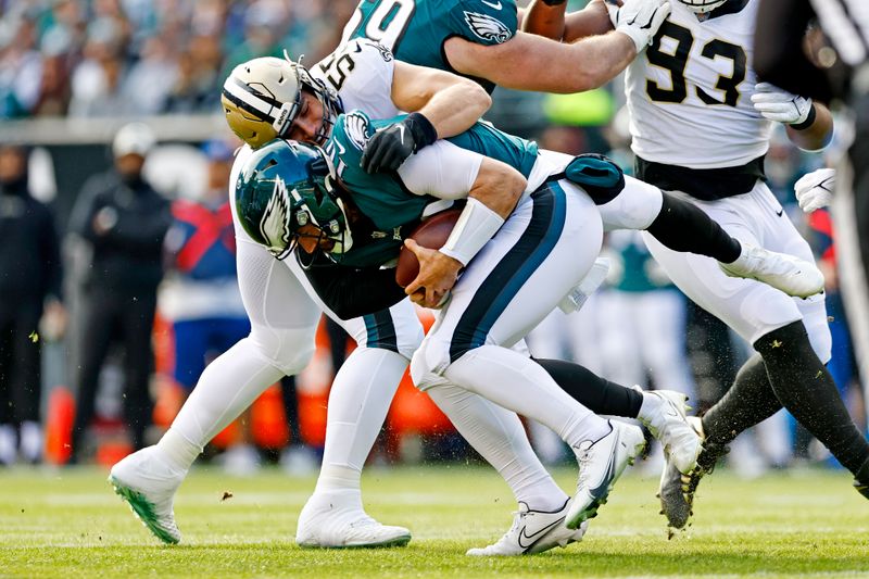 Philadelphia Eagles quarterback Gardner Minshew (10) is sacked by New Orleans Saints linebacker Kaden Elliss (55) during the first quarter during an NFL football game, Sunday, Jan. 1, 2023, in Philadelphia. (AP Photo/Rich Schultz)