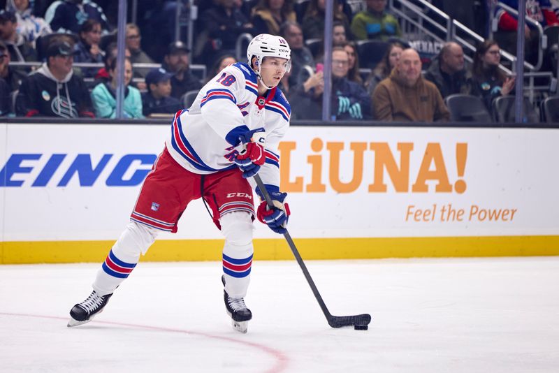 Nov 1, 2025; Seattle, Washington, USA; New York Rangers defenseman Urho Vaakanainen (18) passes the puck during the first period against the Seattle Kraken at Climate Pledge Arena. Mandatory Credit: Blake Dahlin-Imagn Images