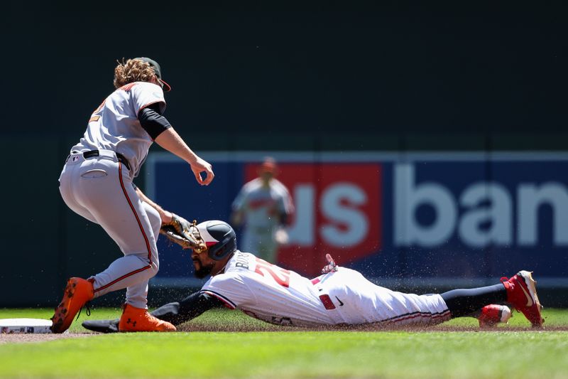 May 8, 2025; Minneapolis, Minnesota, USA; Minnesota Twins center fielder Byron Buxton (25) steals second base as Baltimore Orioles shortstop Gunnar Henderson (2) attempts a tag during the first inning at Target Field. Mandatory Credit: Matt Krohn-Imagn Images