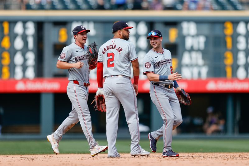 Jun 23, 2024; Denver, Colorado, USA; Washington Nationals center fielder Jacob Young (30) and right fielder Lane Thomas (28) celebrate with second baseman Luis Garcia Jr. (2) after the game against the Colorado Rockies at Coors Field. Mandatory Credit: Isaiah J. Downing-USA TODAY Sports