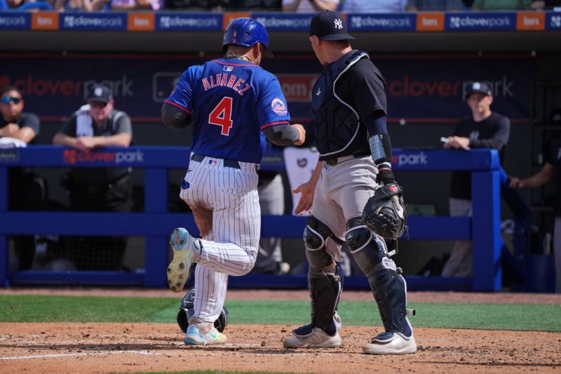 Mar 5, 2024; Port St. Lucie, Florida, USA;  New York Mets catcher Francisco Alvarez (4) scores a run in the third inning as New York Yankees catcher Ben Rortvedt (38) looks for the ball at Clover Park. Mandatory Credit: Jim Rassol-USA TODAY Sports