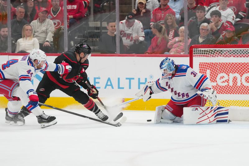 Nov 15, 2025; Raleigh, North Carolina, USA; New York Rangers goaltender Igor Shesterkin (31) stops the shot attempt by Carolina Hurricanes left wing Taylor Hall (71) during the first period at Lenovo Center. Mandatory Credit: James Guillory-Imagn Images