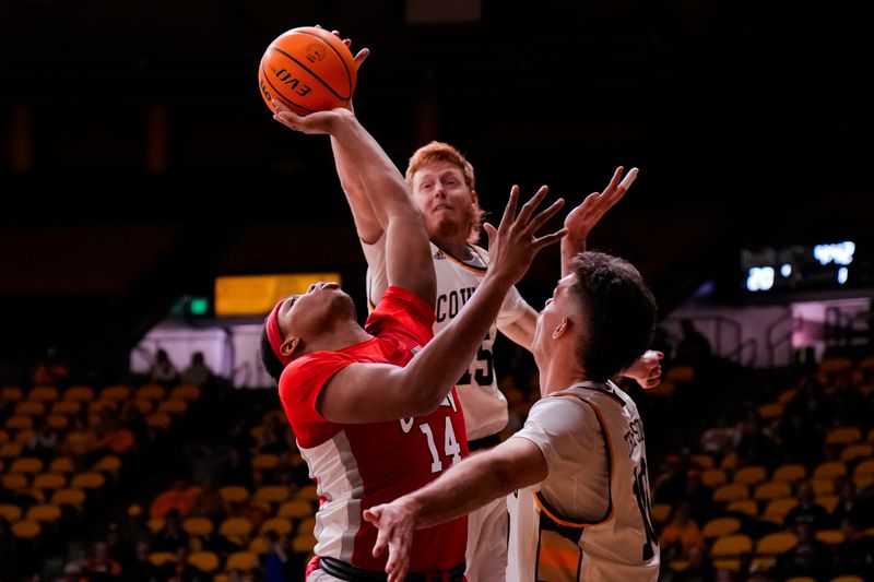 Feb 8, 2023; Laramie, Wyoming, USA; UNLV Runnin' Rebels guard Keyshawn Hall (14) is fouled by Wyoming Cowboys forward Nate Barnhart (15) during the first half at Arena-Auditorium. Mandatory Credit: Troy Babbitt-USA TODAY Sports