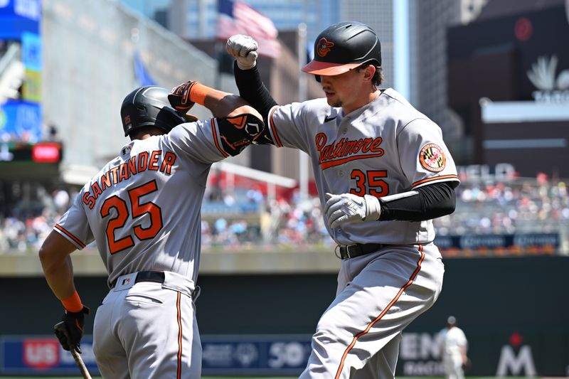 Jul 9, 2023; Minneapolis, Minnesota, USA; Baltimore Orioles catcher Adley Rutschman (35) celebrates with right fielder Anthony Santander (25)) after Rutschman hit a two-run home run off Minnesota Twins relief pitcher Cole Sands (not pictured) during the sixth inning at Target Field. Mandatory Credit: Jeffrey Becker-USA TODAY Sports