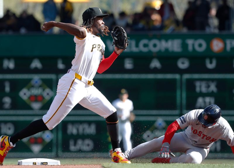 Apr 20, 2024; Pittsburgh, Pennsylvania, USA; Pittsburgh Pirates shortstop Oneil Cruz (15) turns a double play over Boston Red Sox second baseman Enmanuel Valdez (47) during the third inning at PNC Park. Mandatory Credit: Charles LeClaire-USA TODAY Sports