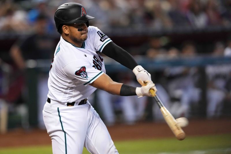 Sep 4, 2023; Phoenix, Arizona, USA; Arizona Diamondbacks catcher Gabriel Moreno (14) hits an RBI single against the Colorado Rockies during the fourth inning at Chase Field. Mandatory Credit: Joe Camporeale-USA TODAY Sports