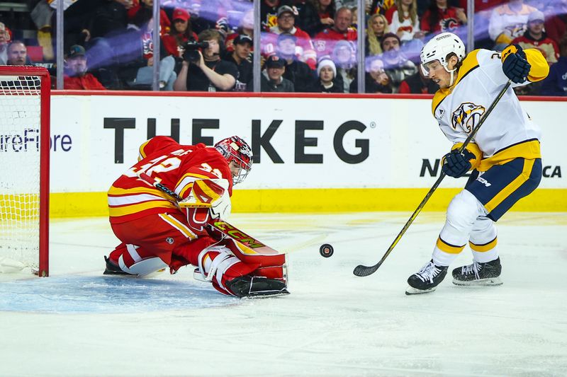 Nov 15, 2024; Calgary, Alberta, CAN; Calgary Flames goaltender Dustin Wolf (32) makes a save against Nashville Predators center Philip Tomasino (26) during the first period at Scotiabank Saddledome. Mandatory Credit: Sergei Belski-Imagn Images