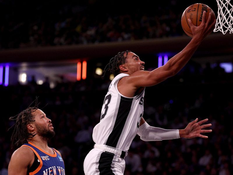 NEW YORK, NEW YORK - NOVEMBER 08: Tre Jones #33 of the San Antonio Spurs shoots the ball against Jalen Brunson #11 of the New York Knicks during the second quarter in the game at Madison Square Garden on November 08, 2023 in New York City. NOTE TO USER: User expressly acknowledges and agrees that, by downloading and or using this photograph, User is consenting to the terms and conditions of the Getty Images License Agreement. (Photo by Elsa/Getty Images)