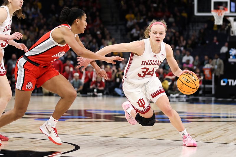 Mar 4, 2023; Minneapolis, MINN, USA; Indiana Hoosiers guard Grace Berger (34) drives to the basket while Ohio State Buckeyes forward Taylor Thierry (2) defends during the second half at Target Center. Mandatory Credit: Matt Krohn-USA TODAY Sports