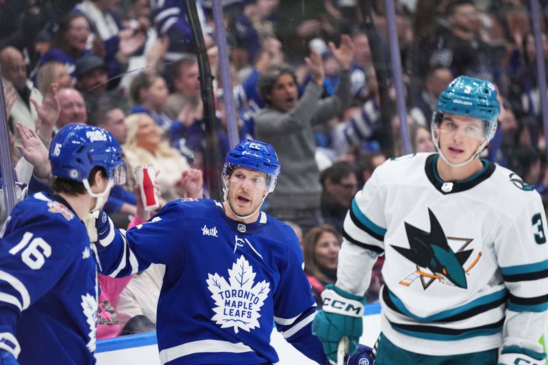 Jan 9, 2024; Toronto, Ontario, CAN; Toronto Maple Leafs defenseman Jake McCabe (22) scores a goal and celebrates with right wing Mitchell Marner (16)] against the San Jose Sharks during the third period at Scotiabank Arena. Mandatory Credit: Nick Turchiaro-USA TODAY Sports