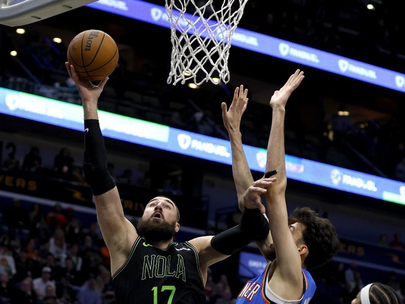 NEW ORLEANS, LOUISIANA - JANUARY 26: Jonas Valanciunas #17 of the New Orleans Pelicans shoots over Chet Holmgren #7 of the Oklahoma City Thunder during the second quarter of an NBA game at Smoothie King Center on January 26, 2024 in New Orleans, Louisiana. NOTE TO USER: User expressly acknowledges and agrees that, by downloading and or using this photograph, User is consenting to the terms and conditions of the Getty Images License Agreement. (Photo by Sean Gardner/Getty Images)