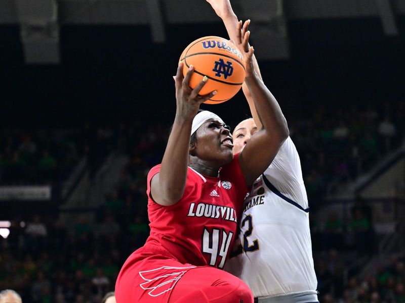 Mar 3, 2024; South Bend, Indiana, USA; Louisville Cardinals forward Olivia Cochran (44) goes up for a shot as Notre Dame Fighting Irish forward Kylee Watson (22) defends in the first half at the Purcell Pavilion. Mandatory Credit: Matt Cashore-USA TODAY Sports