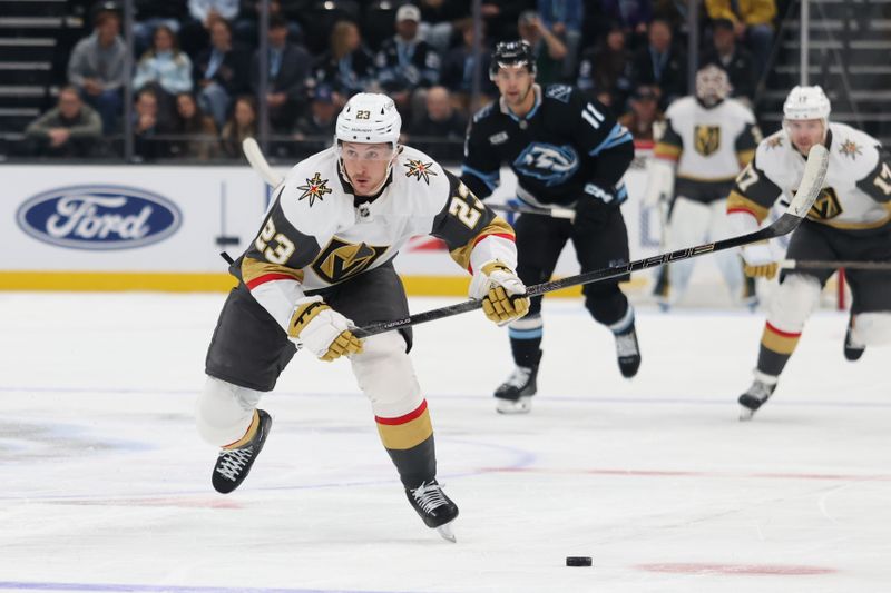 Nov 24, 2025; Salt Lake City, Utah, USA; Vegas Golden Knights left wing Cole Reinhardt (23) advances the puck against the Utah Mammoth during the first period at Delta Center. Mandatory Credit: Rob Gray-Imagn Images